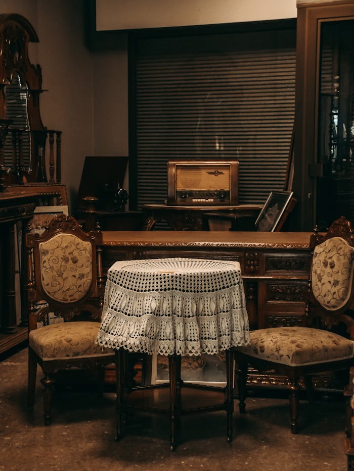 Cozy vintage room with antique furniture and lace-covered table